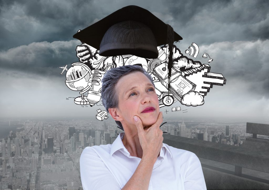 thoughtful female executive with mortar board above head